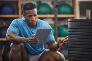 Athletes reviewing performance data on a tablet during training.
